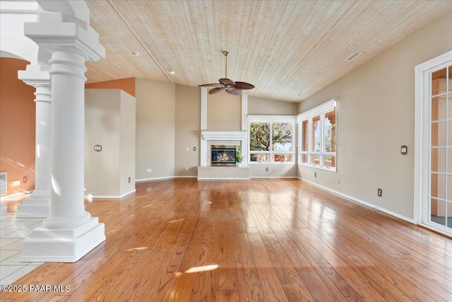 unfurnished living room featuring ornate columns, ceiling fan, vaulted ceiling, wooden ceiling, and light wood-type flooring