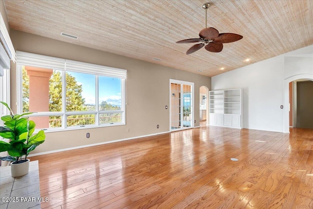 unfurnished living room with visible vents, a ceiling fan, arched walkways, wooden ceiling, and light wood finished floors