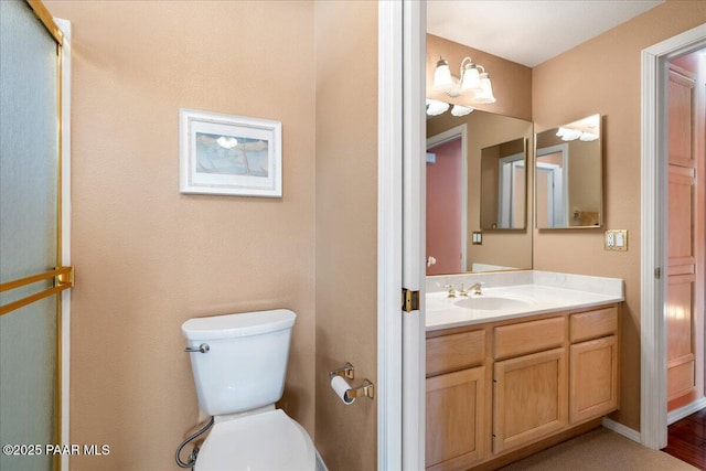 full bath featuring vanity, toilet, and a shower with shower door