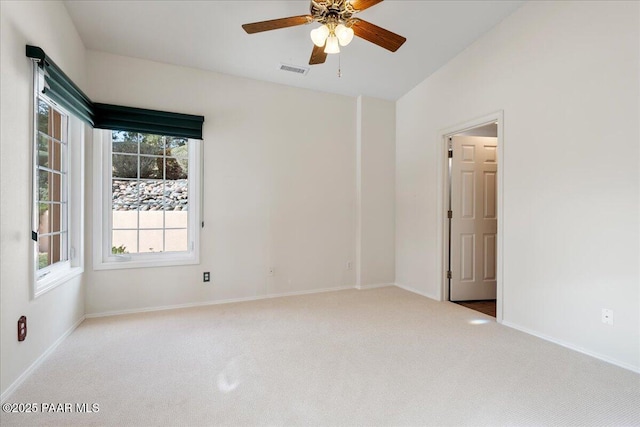 unfurnished room with a ceiling fan, carpet, visible vents, and baseboards