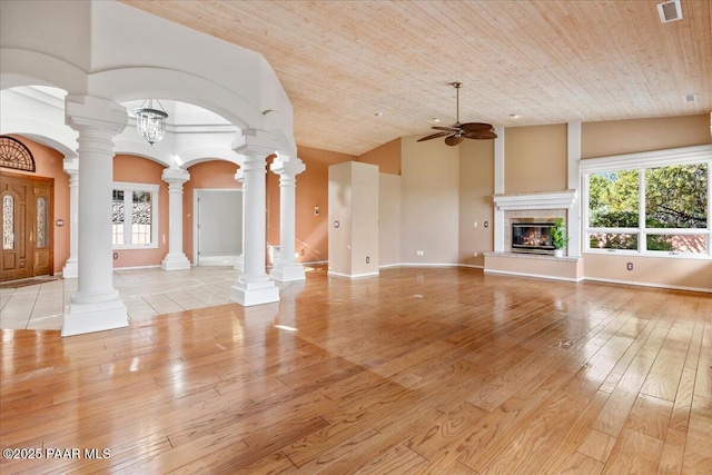 unfurnished living room with visible vents, ceiling fan, light wood-type flooring, wooden ceiling, and high vaulted ceiling