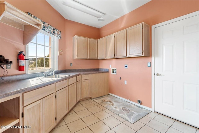 clothes washing area featuring hookup for a washing machine, light tile patterned floors, gas dryer hookup, hookup for an electric dryer, and a sink