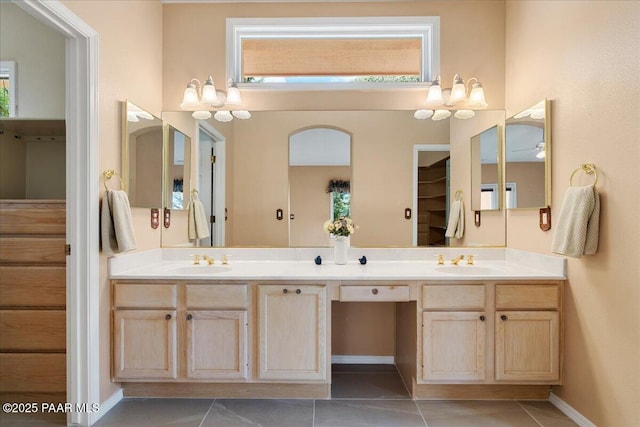 bathroom with tile patterned flooring, double vanity, and a sink