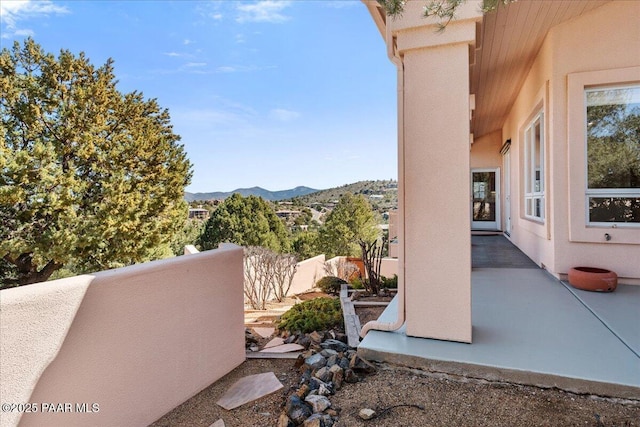 view of patio / terrace featuring a mountain view and a balcony