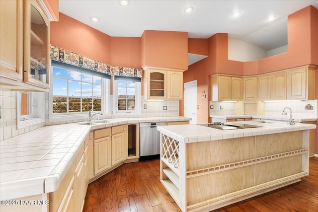 kitchen featuring tile countertops, black electric stovetop, stainless steel dishwasher, and a sink