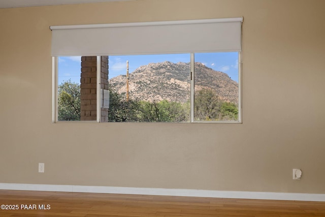 2615 W Red Tail Way, Prescott, AZ 86305 - empty room featuring baseboards, wood finished floors, and a mountain view