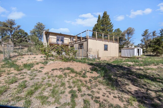 2615 W Red Tail Way, Prescott, AZ 86305 - rear view of property featuring a storage unit, an outbuilding, a deck, and fence