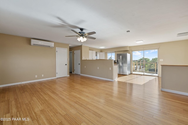 2615 W Red Tail Way, Prescott, AZ 86305 - unfurnished living room featuring a wall mounted AC, a ceiling fan, baseboards, and light wood finished floors