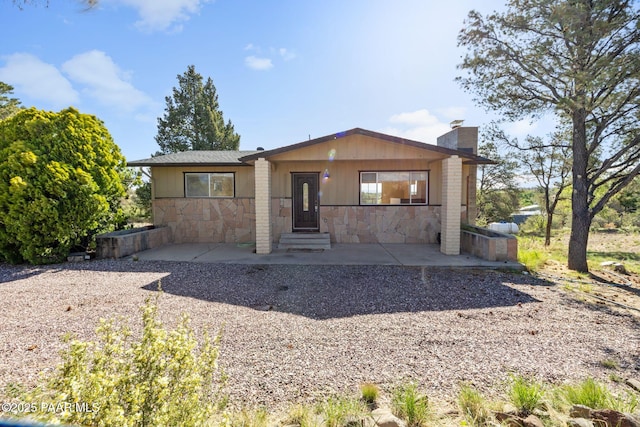 2615 W Red Tail Way, Prescott, AZ 86305 - view of front of house with stone siding, a chimney, and entry steps
