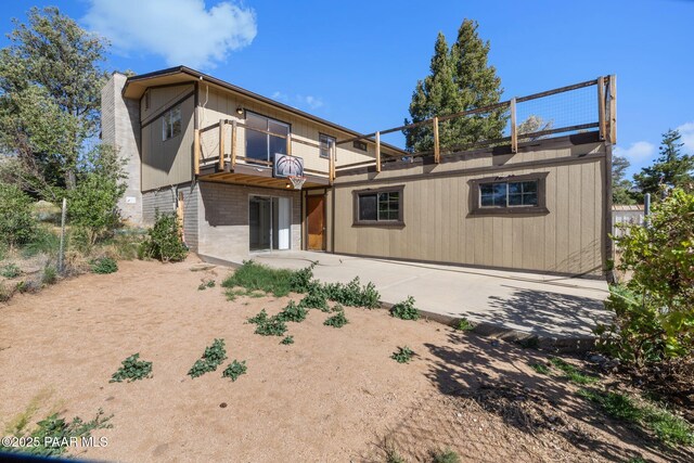 2615 W Red Tail Way, Prescott, AZ 86305 - rear view of house with a balcony, brick siding, and a patio area