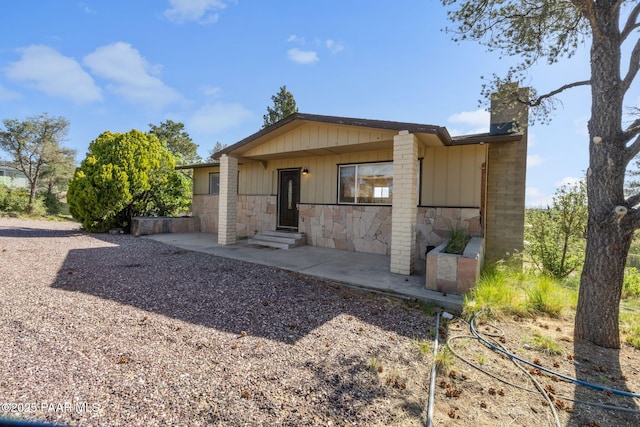 2615 W Red Tail Way, Prescott, AZ 86305 - back of property featuring stone siding, a chimney, and board and batten siding