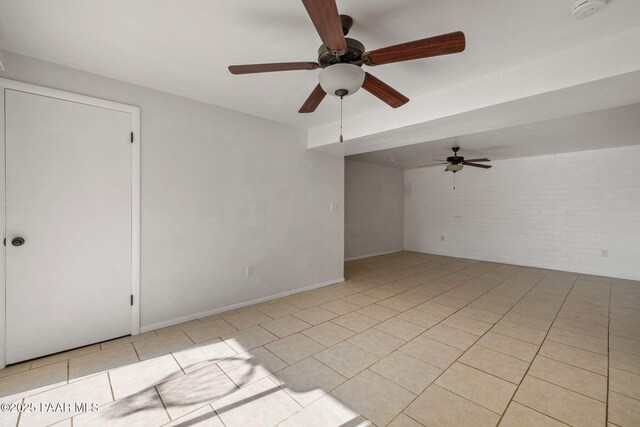 2615 W Red Tail Way, Prescott, AZ 86305 - spare room featuring ceiling fan, light tile patterned flooring, a smoke detector, brick wall, and baseboards