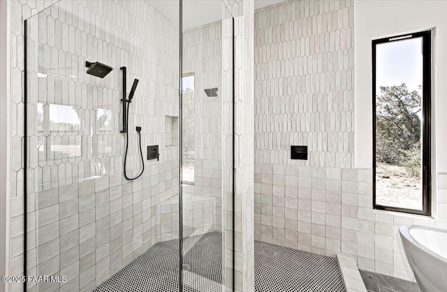 bathroom with tile walls, a soaking tub, and tiled shower