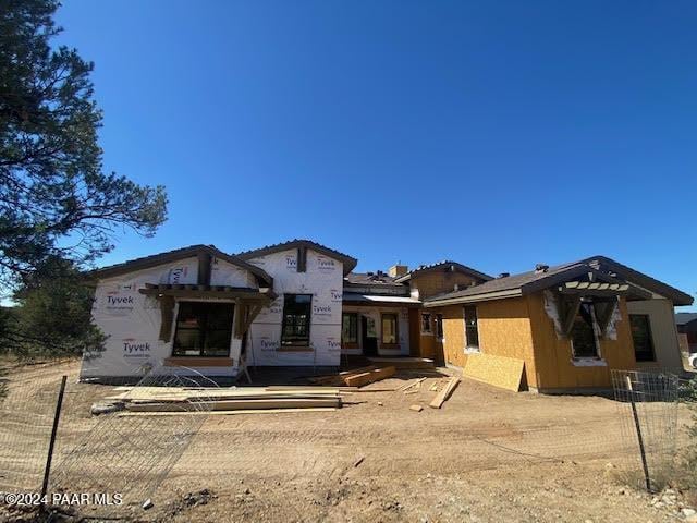 property in mid-construction with fence