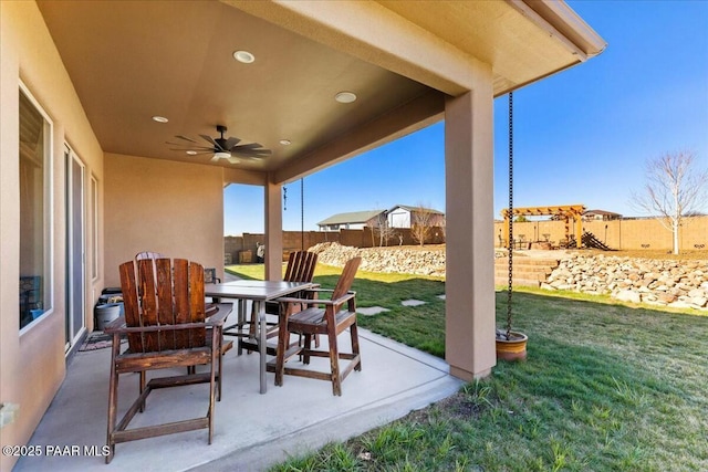 view of patio / terrace with a ceiling fan, outdoor dining area, and a fenced backyard