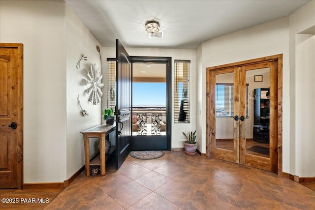 entrance foyer with french doors, baseboards, and visible vents