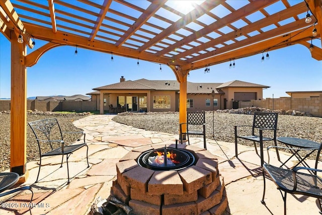 view of patio / terrace featuring a pergola, a fire pit, and fence