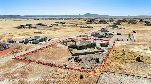 aerial view featuring a mountain view, a rural view, and view of desert
