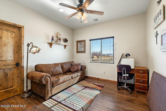 living room with visible vents, baseboards, a ceiling fan, and wood finished floors