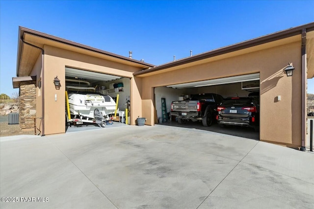 garage featuring cooling unit and driveway