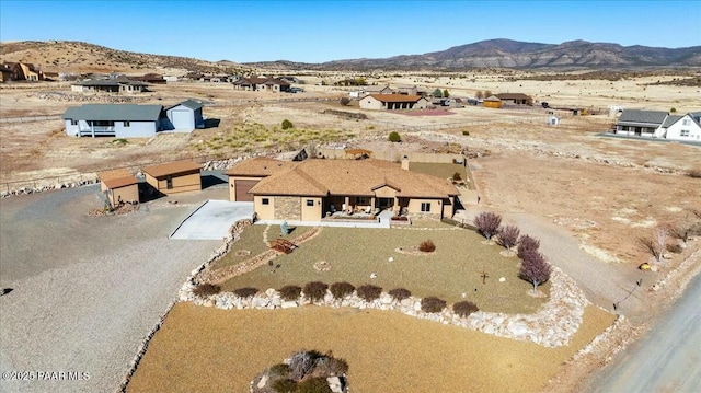 birds eye view of property featuring view of desert and a mountain view
