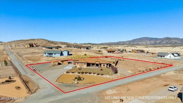 birds eye view of property featuring a rural view, a mountain view, and view of desert