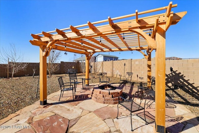 view of patio / terrace featuring a fenced backyard, a pergola, and an outdoor fire pit