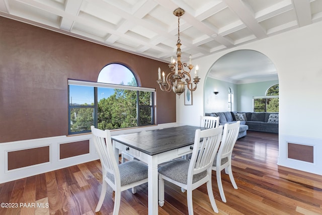 dining room featuring a chandelier, hardwood / wood-style flooring, plenty of natural light, and crown molding