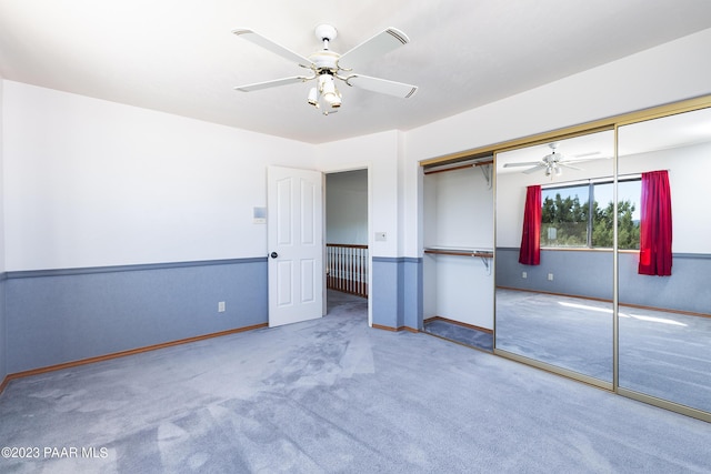 unfurnished bedroom featuring carpet flooring, a closet, and ceiling fan