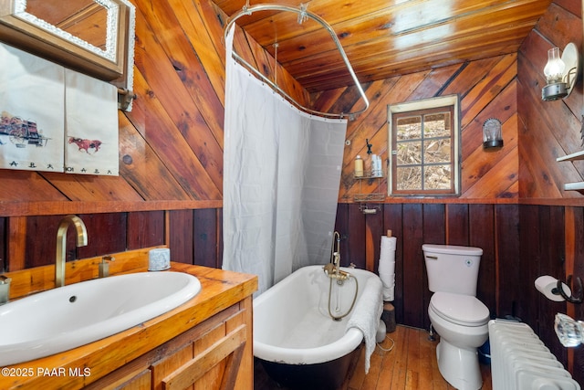 4555 E Combination Ln, Prescott, AZ 86303 - full bath featuring radiator heating unit, wood walls, toilet, a bath, and curtained shower