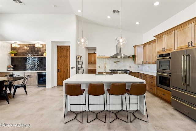 kitchen featuring appliances with stainless steel finishes, visible vents, a sink, decorative backsplash, and finished concrete flooring
