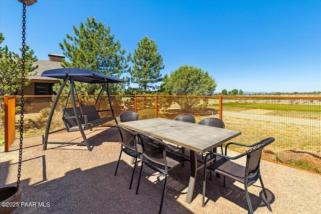 view of patio featuring fence and outdoor dining space