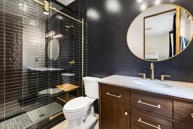 bathroom featuring visible vents, vanity, a shower stall, and toilet