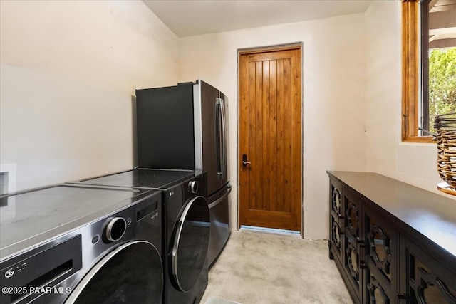 washroom with separate washer and dryer, light carpet, and laundry area
