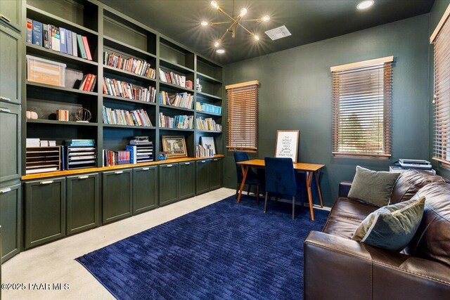 carpeted office space featuring visible vents, recessed lighting, and a notable chandelier