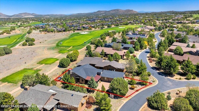drone / aerial view with a mountain view, a residential view, and view of golf course