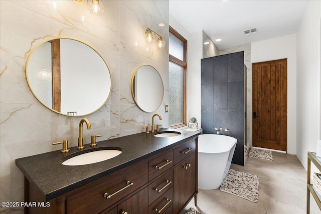 full bathroom with a soaking tub, a sink, visible vents, and finished concrete flooring