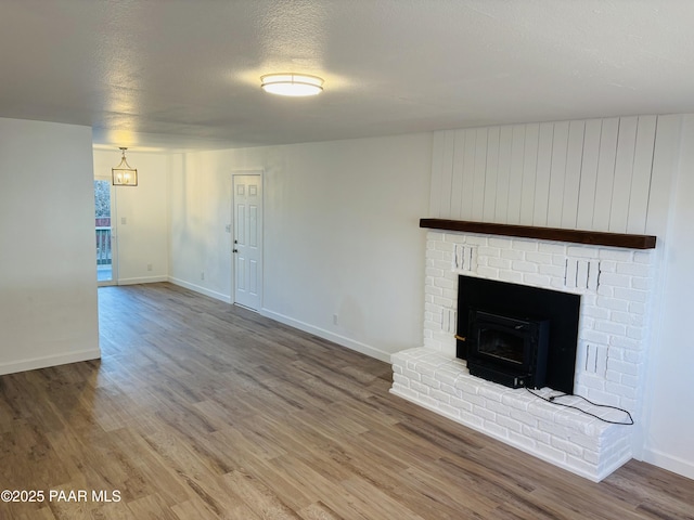 unfurnished living room featuring hardwood / wood-style floors and a textured ceiling