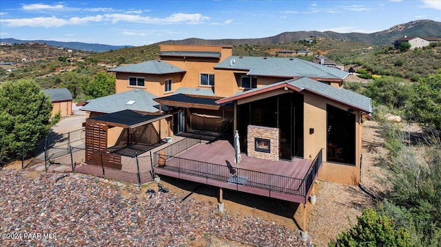 414 N Fitzmaurice Dr, Prescott, AZ 86303 - back of house featuring stone siding, a mountain view, and stucco siding
