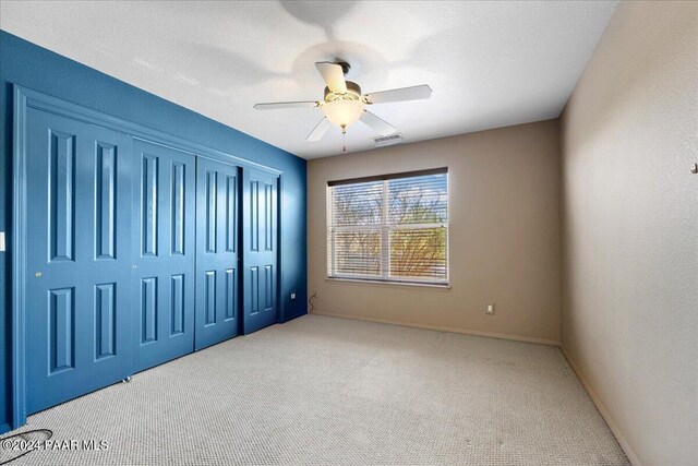 414 N Fitzmaurice Dr, Prescott, AZ 86303 - unfurnished bedroom with a closet, carpet floors, a textured ceiling, visible vents, and ceiling fan
