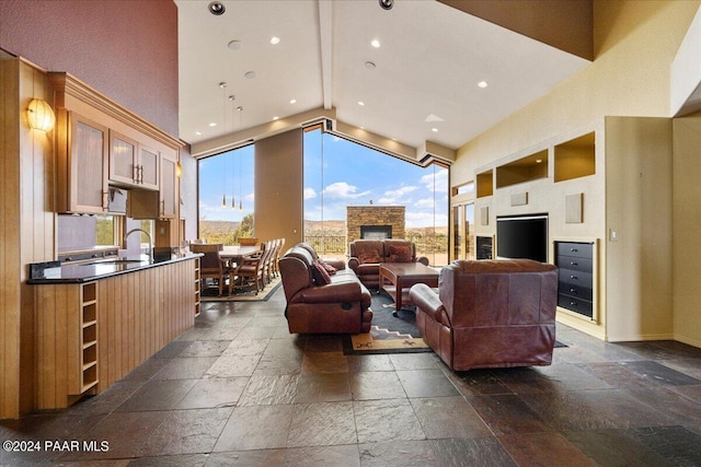 414 N Fitzmaurice Dr, Prescott, AZ 86303 - living room featuring recessed lighting, high vaulted ceiling, stone tile flooring, and a healthy amount of sunlight