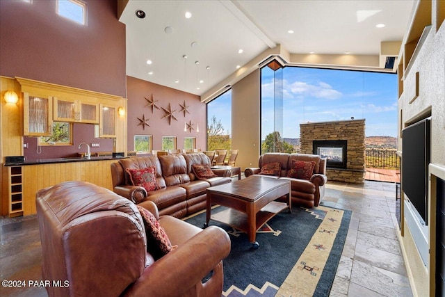 414 N Fitzmaurice Dr, Prescott, AZ 86303 - living area with stone tile floors, high vaulted ceiling, beam ceiling, a wealth of natural light, and a stone fireplace