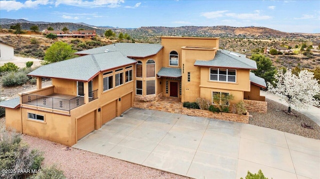 414 N Fitzmaurice Dr, Prescott, AZ 86303 - view of front of home featuring a balcony, stone siding, a garage, driveway, and a mountain view