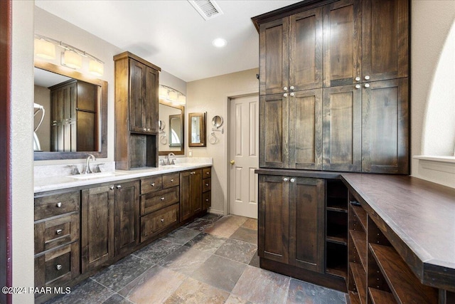 414 N Fitzmaurice Dr, Prescott, AZ 86303 - full bath featuring visible vents, a sink, double vanity, and stone finish flooring