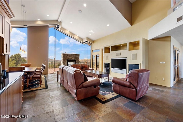414 N Fitzmaurice Dr, Prescott, AZ 86303 - living area with high vaulted ceiling, stone tile flooring, baseboards, and a healthy amount of sunlight