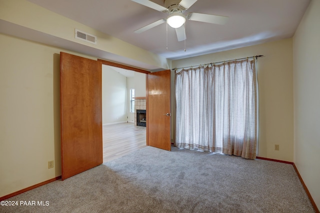 253 Creekside Cir Unit B, Prescott, AZ 86303 - carpeted empty room featuring baseboards, a ceiling fan, visible vents, and a fireplace