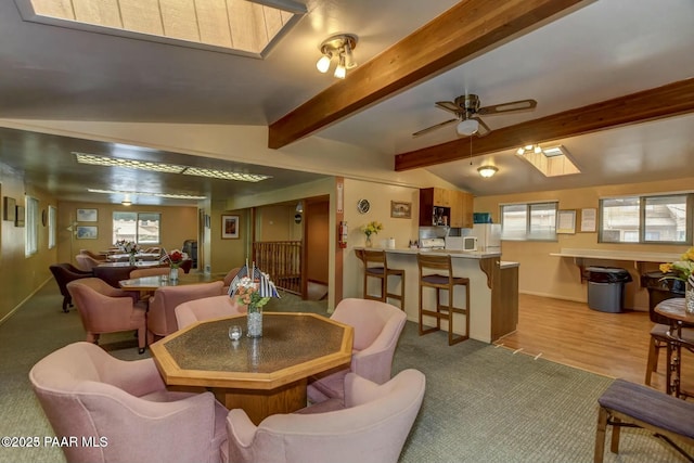 253 Creekside Cir Unit B, Prescott, AZ 86303 - dining room featuring light colored carpet, ceiling fan, baseboards, and lofted ceiling with skylight