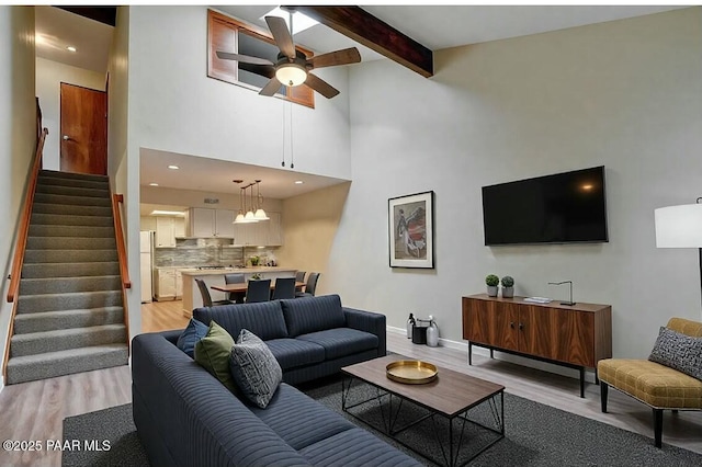 253 Creekside Cir Unit B, Prescott, AZ 86303 - living room featuring a ceiling fan, stairs, light wood-style floors, baseboards, and beam ceiling