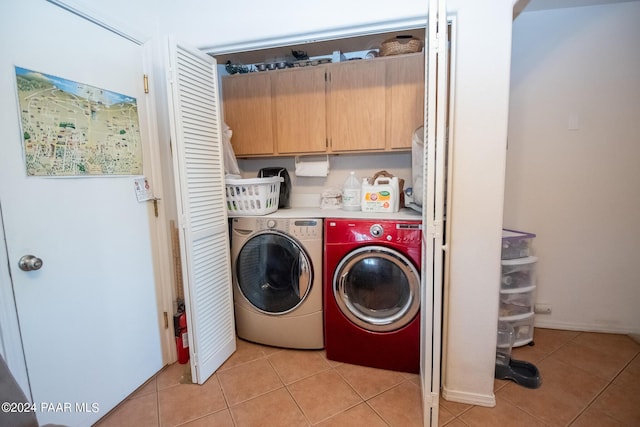 laundry room featuring light tile patterned flooring and washing machine and clothes dryer