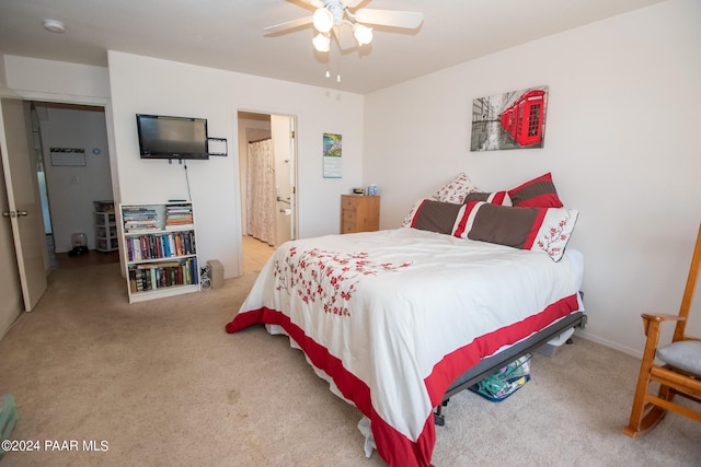 bedroom featuring light carpet, connected bathroom, and ceiling fan